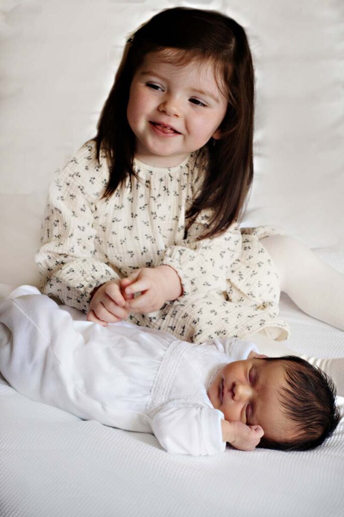 photo of baby and older sister - baby photographer