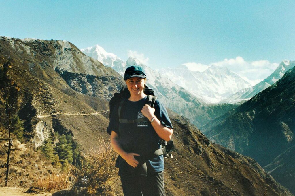 Siobhan on her travels with a snow capped moutain behind her