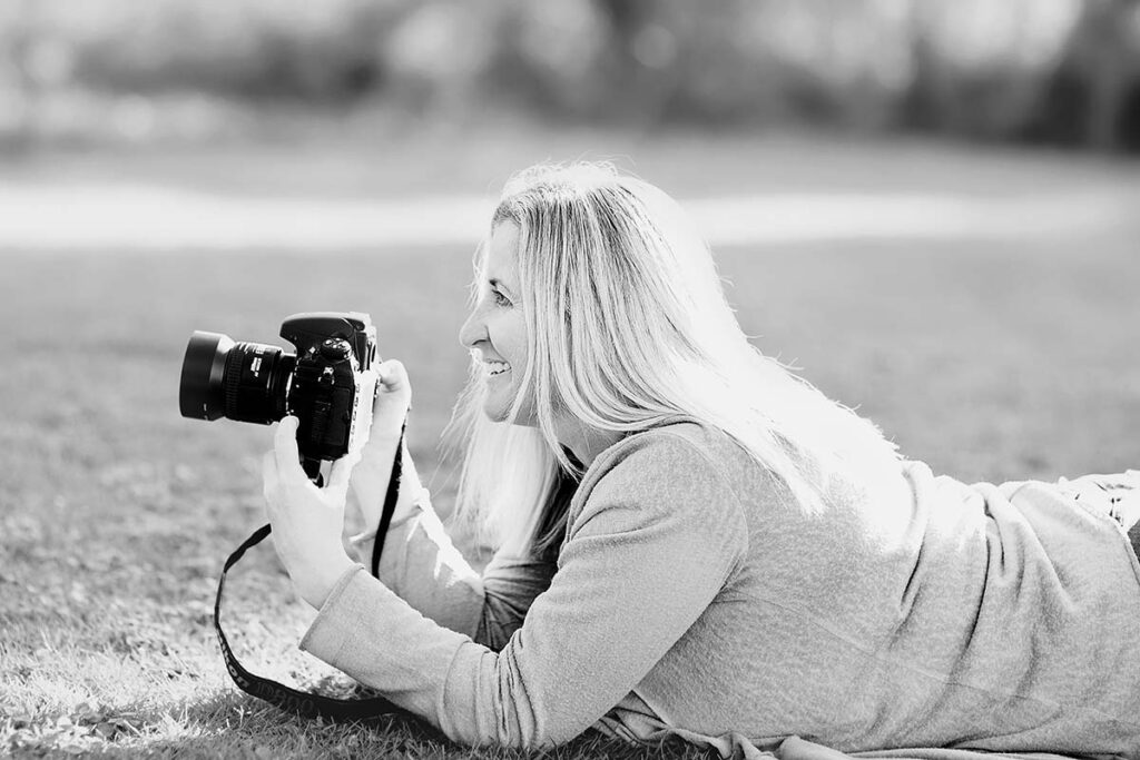 Milton Keynes Family Photographer Siobhan Murphy lay on the ground with her camera